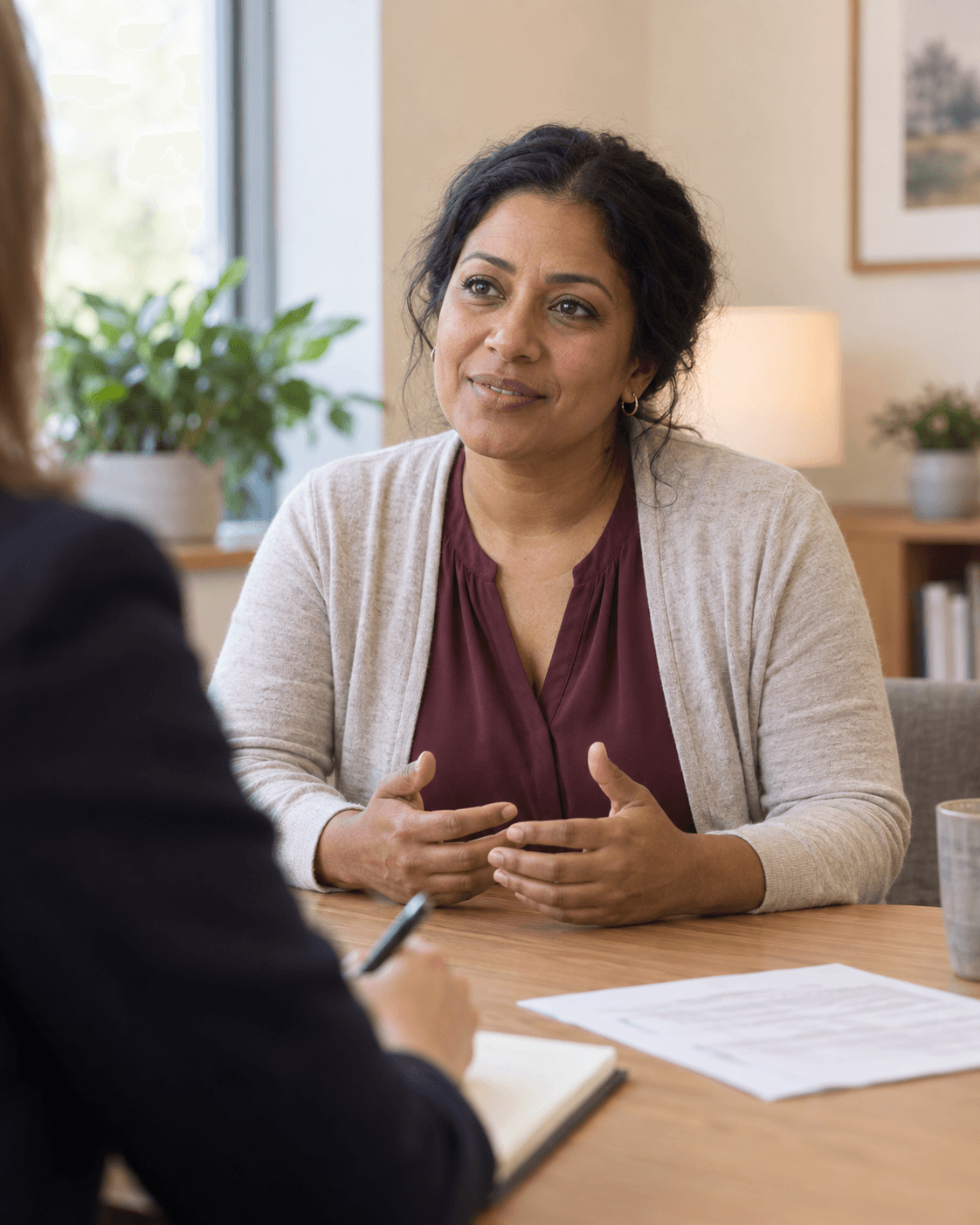 An employee speaking with an attentive advocate during a consultation